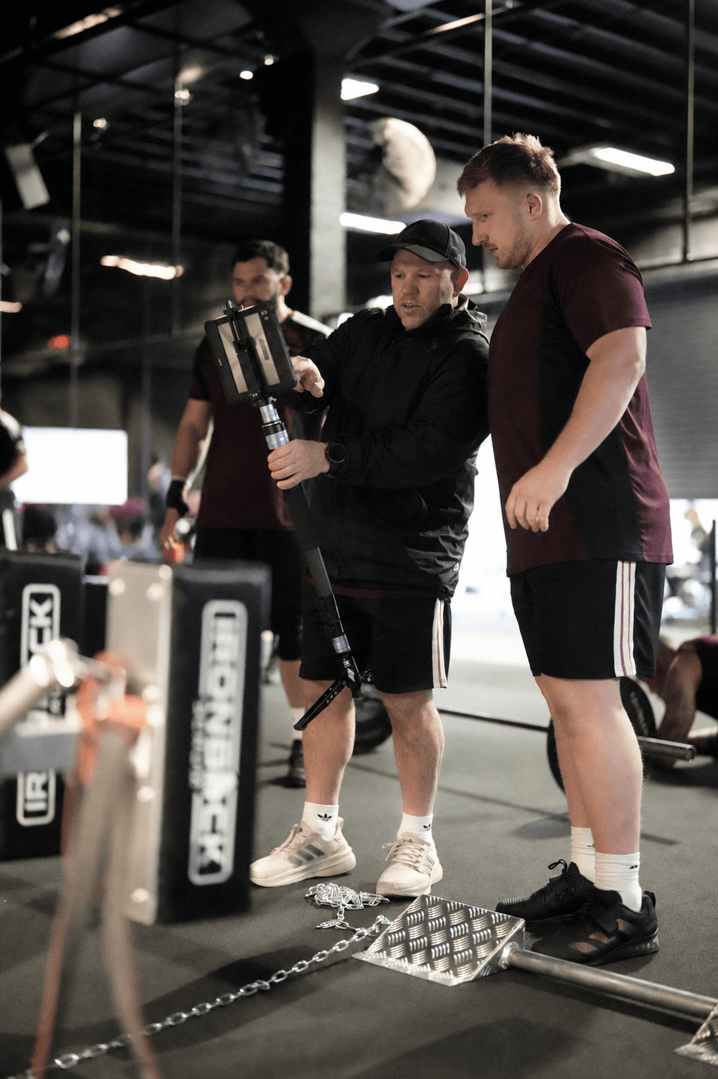 Coach reviewing footage with an athlete on the Ironback Rig